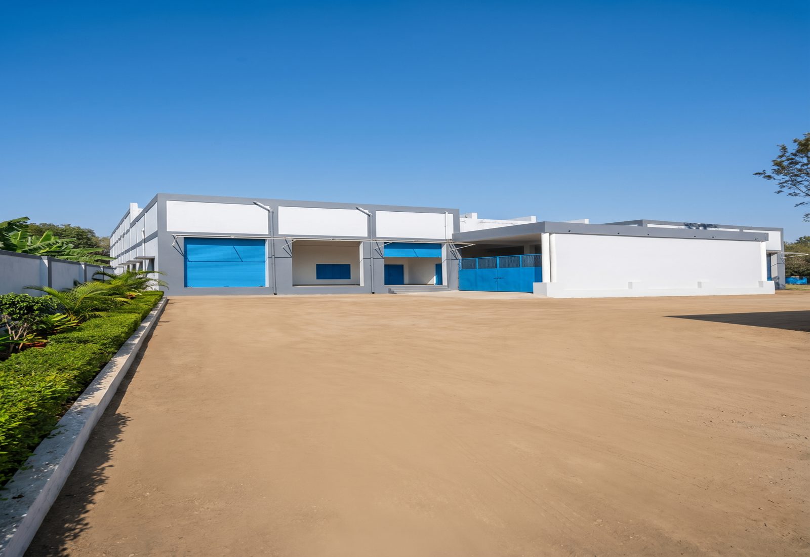 Front elevation of the warehouse with entry forecourt and loading shutters
